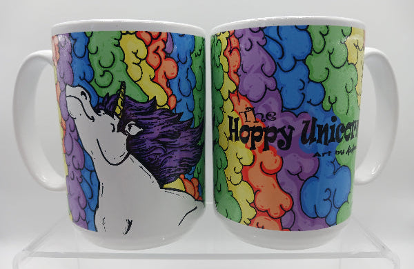 Colorful mug with a unicorn design and rainbow cloud pattern on a white background